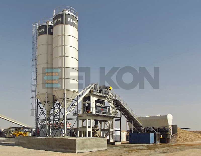Industrial cement plant with silos and machinery.