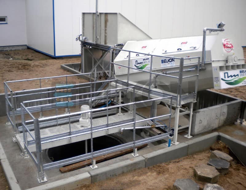 Concrete batching plant machinery with safety railings