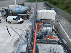 Industrial site with vehicles and equipment.