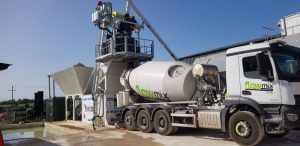 Concrete mixing truck at construction site.