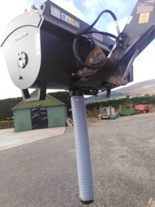 Industrial machine part with flexible hose outdoors