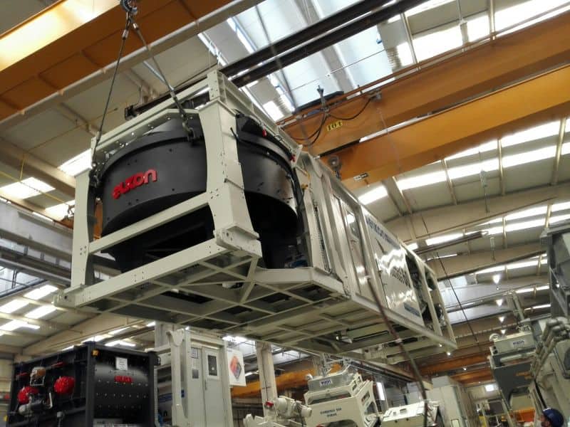 Large industrial machine being lifted in factory