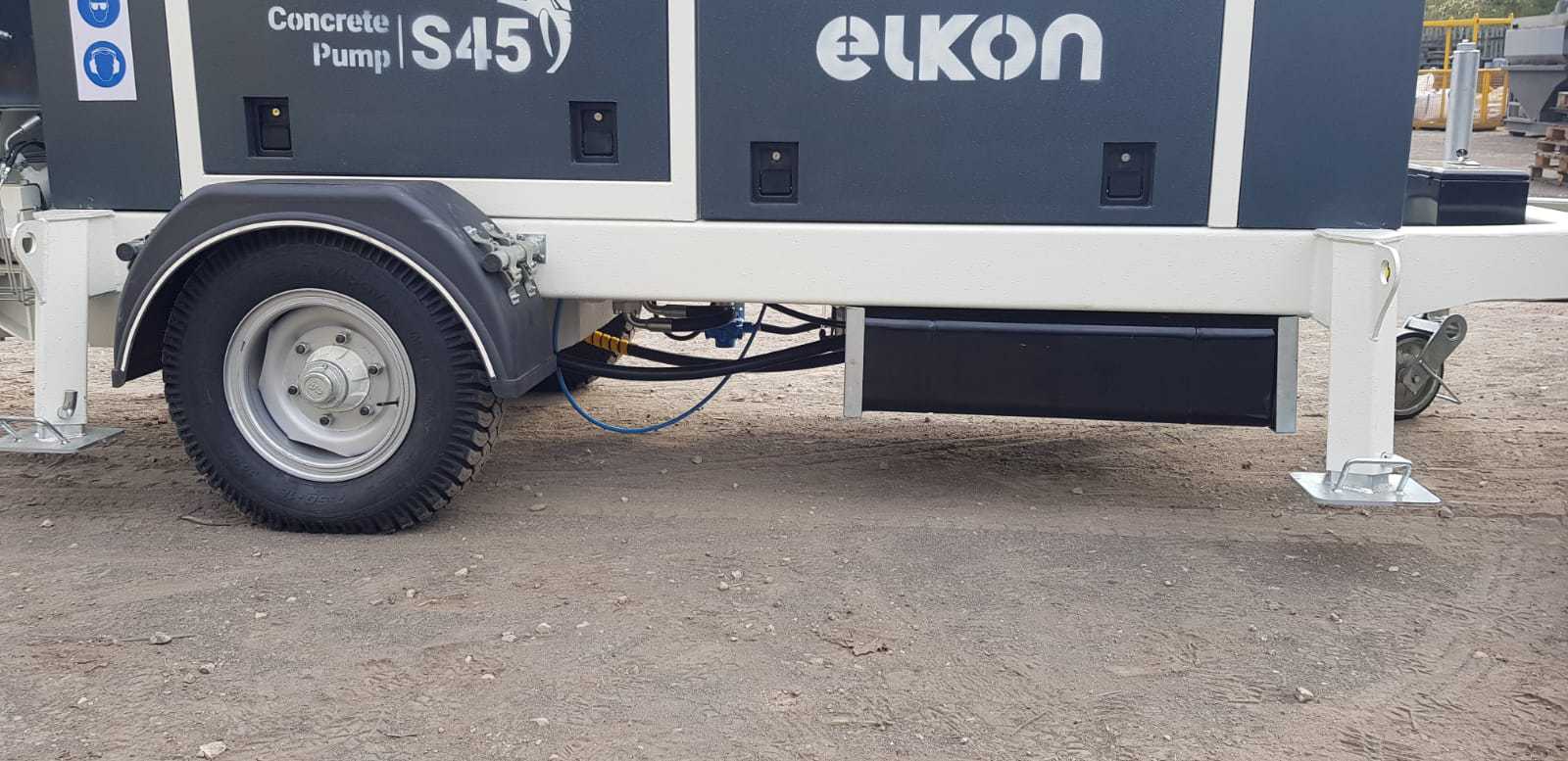 Concrete pump trailer on construction site.