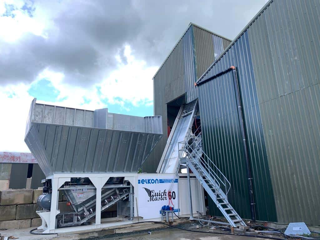 Industrial concrete batching plant with conveyor system.