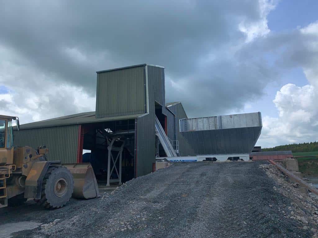 Industrial building with machinery and cloudy sky
