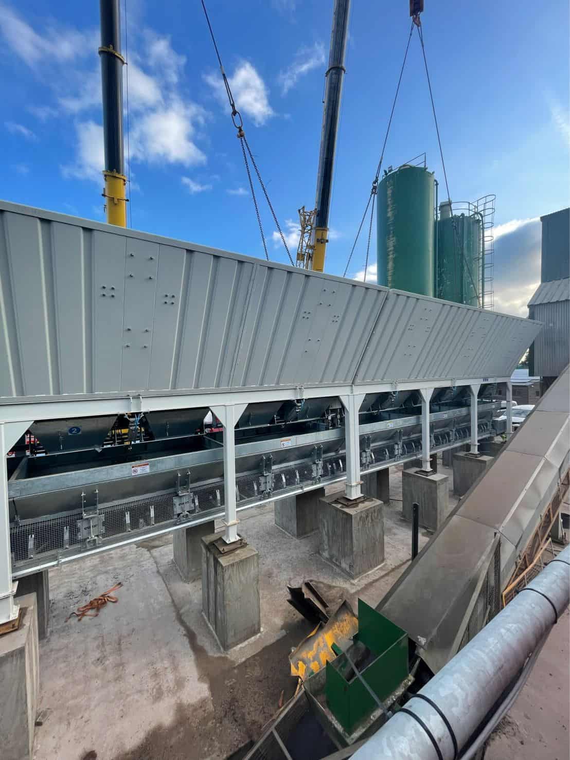 Construction site with large industrial machinery and cranes.