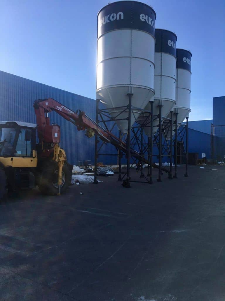 Industrial silos and machinery at construction site.