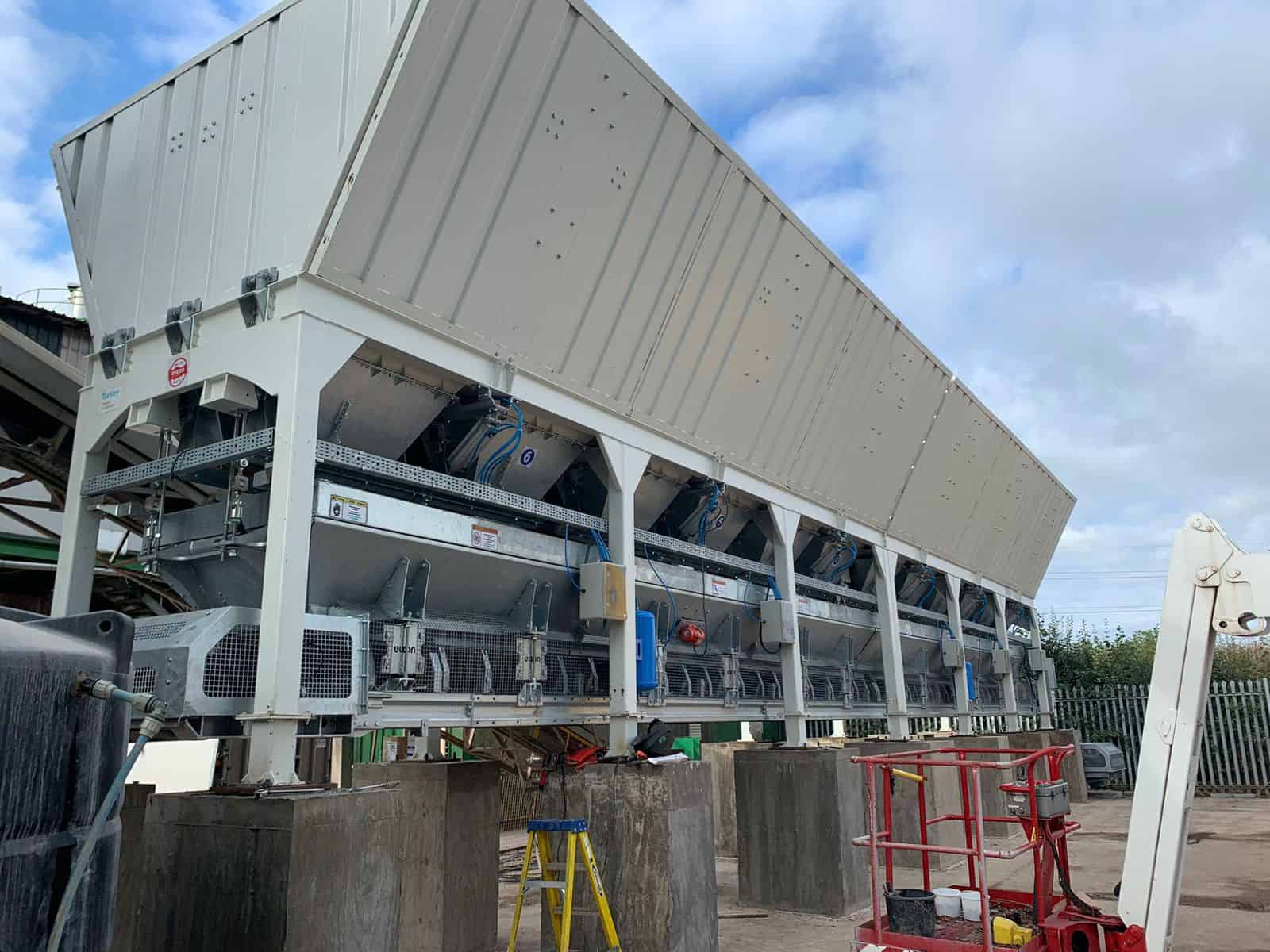 Industrial concrete batching plant machinery outdoors.