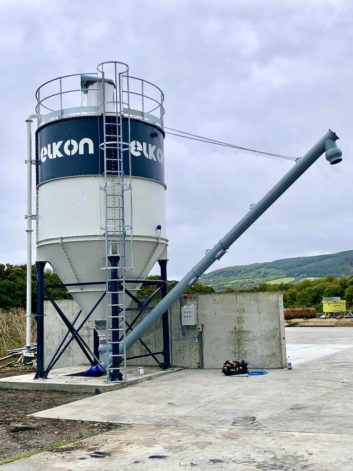 Large industrial concrete silo on construction site.