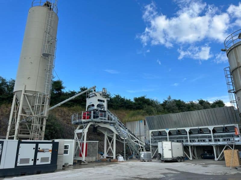 Industrial site with silos and machinery.